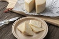 Brazilian Mantiqueira artisanal cheese with slices over a wooden table