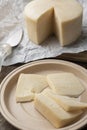 Brazilian Mantiqueira artisanal cheese with slices over a wooden table