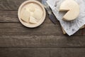 Brazilian Mantiqueira artisanal cheese with slices over a wooden table. Top view with copy space