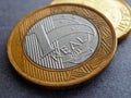 Brazilian 1 one real coin close-up. Illustration about economy, finance and banks. Money in Brazil. Focus on the name of the