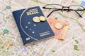 Brazilian passport, euros, glasses and map for travel abroad. Royalty Free Stock Photo