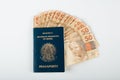 Brazilian passport with fifty reais banknotes. Brazilian money