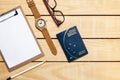 Brazilian Passport on the wooden table and itens for traveling