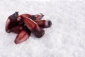 Brazilian Pinion fruit in coarse salt background Royalty Free Stock Photo