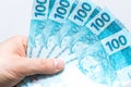 Brazilian Real. Money spread out in a fan, held in a man`s hand Royalty Free Stock Photo