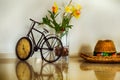 Brazilian straw hat on desk with bicycle clock and flower