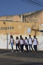 Brazilian students in uniform walk across the street