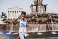 Brazilian teenage girl using cellphone to photograph herself near fountain Royalty Free Stock Photo