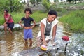 Brazilian woman washing clothes in river, Brazil