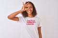 Brazilian woman wearing fanny t-shirt with irony comments over isolated white background with happy face smiling doing ok sign