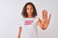 Brazilian woman wearing fanny t-shirt with irony comments over isolated white background with open hand doing stop sign with