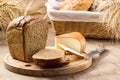 Bread and cheese sliced for sandwiches amid the loaves in a wicker basket with ears of wheat Royalty Free Stock Photo