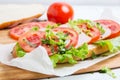 Bread baguette sandwich with ham, tomatoes and lettuce Royalty Free Stock Photo