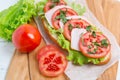 Bread baguette sandwich with ham, tomatoes and lettuce Royalty Free Stock Photo