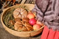 Bread baked on retro technology is with apples in the basket. Reconstruction of cooking in the ancient era. Vintage pastries, cake