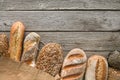 Bread bakery background. Brown and white wheat grain loaves composition on rustic wood Royalty Free Stock Photo