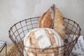 Bread in the basket. loaf and baguette in the kitchen, homemade pastries with powder. delicious flour products