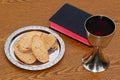 Bread, Bible and Chalice on wood table