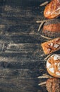 Bread border on wood background with copy space. Whole grain loaves with spikelets. Different types of bread. Bakery