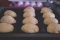 Bread buns dough shaped and ready for baking in the oven Royalty Free Stock Photo