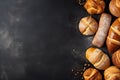 Bread, buns and bread rolls on black background, top view, flat lay, copy space