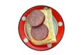 Bread with butter, cheese, sausage on a red-white ceramic dish i Royalty Free Stock Photo