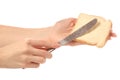 Bread with butter knife in hand Royalty Free Stock Photo