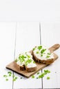 Bread with butter and spread. Concept of healthy breakfast. Spring onion, Vegetables. Wooden white table with copy space Royalty Free Stock Photo