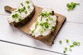 Bread with butter and spread. Concept of healthy breakfast. Spring onion, Vegetables. Wooden white table with copy space Royalty Free Stock Photo