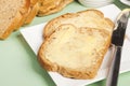 Bread and butter on square white plate