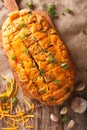 Bread with cheddar cheese, garlic and herbs closeup. Vertical to Royalty Free Stock Photo