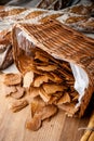 Bread chips. Basket with chips. Scattered crispy pastries. Chips in a wooden basket Royalty Free Stock Photo