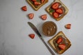 Bread with chocolate paste, brown  nutrition strawberries on a light background Royalty Free Stock Photo