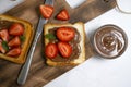 Bread with chocolate paste, dessert nutrition strawberries on a light background Royalty Free Stock Photo