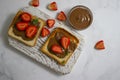 Bread with chocolate paste, cream food strawberries on a light background Royalty Free Stock Photo