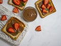 Bread with chocolate paste, sweet food strawberries on a light background Royalty Free Stock Photo