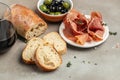 Bread ciabatta, jamon ham serrano paleta iberica, olives and glass of red wine, Tapas, antipasti. top view Royalty Free Stock Photo