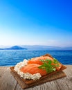 Bread crisp with salmon, rustic table, seascape