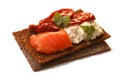 Bread crisp with salmon, soft cheese, dried tomatoes and chervil