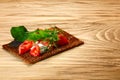 Bread crisp with tomato, cheese and arugula