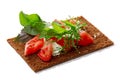 Bread crisp with tomato, soft cheese and greens