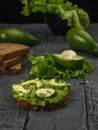 Bread with cucumber, avocado and spices on a wooden table Royalty Free Stock Photo