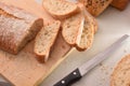 Bread cut into slices on cutting board of kitchen top Royalty Free Stock Photo