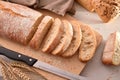 Bread cut into slices on cutting board top view Royalty Free Stock Photo