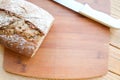 Bread on a cutting board, top view. Carrot bread with grains, background