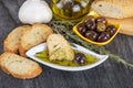 The bread dipped in olive oil with olive. Greek olive oil bread dip. Italian Bread with Oil for Dipping with Herbs Royalty Free Stock Photo