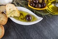 The bread dipped in olive oil with olive. Greek olive oil bread dip. Italian Bread with Oil for Dipping with Herbs & Spices. Royalty Free Stock Photo