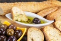 The bread dipped in olive oil with olive. Greek olive oil bread dip. Italian Bread with Oil for Dipping with Herbs & Spices. Royalty Free Stock Photo