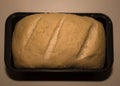 The bread dough has risen and ready for baking. Homemade yeast bread from white flour in a square baking dish. Royalty Free Stock Photo