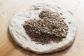 Bread dough with seeds forming a heart Royalty Free Stock Photo